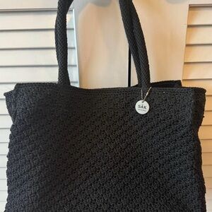 The Sak Black Tote Bag with Woven Texture and Open Top Design